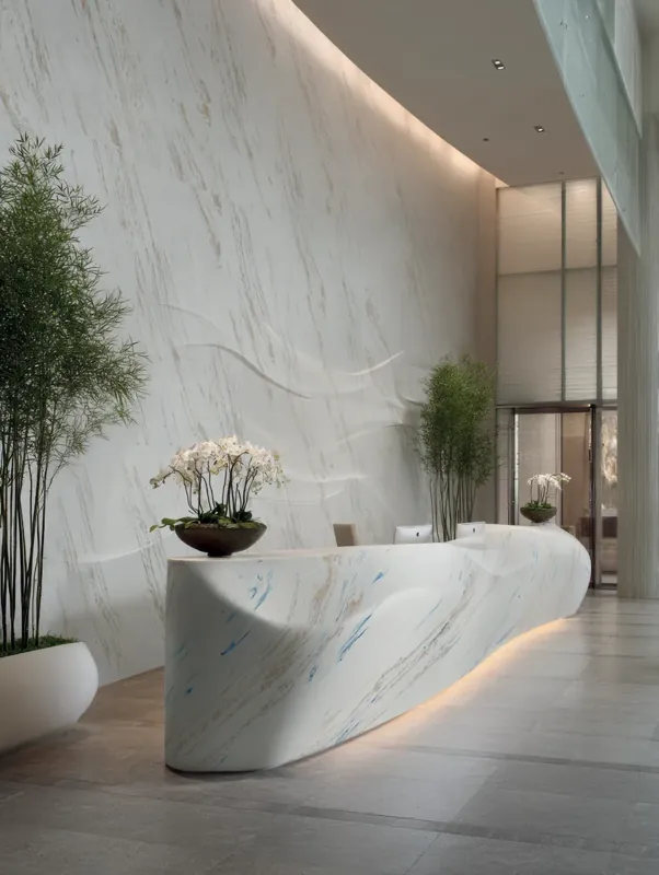Owalna lada recepcyjna z Corian® Vasto Laguna z podświetleniem od dołu