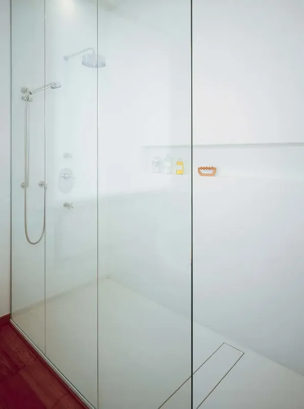 Kabina prysznicowa ze ścianami z białych paneli Corian® Glacier White bez fug